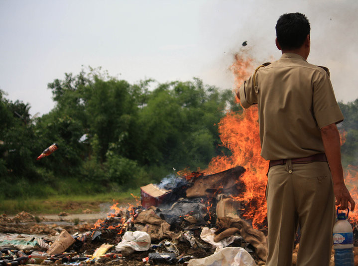 An enforcement personnel watches over desutruction of seized liquor in Nagaland. (File Photo)